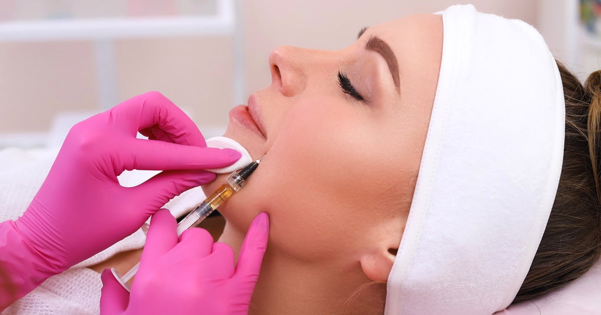 A woman receiving a targeted facial treatment at a beauty salon utilizing Beauty Solutions.