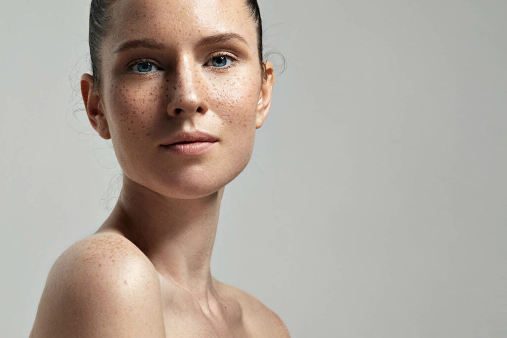 A woman with freckles at home.