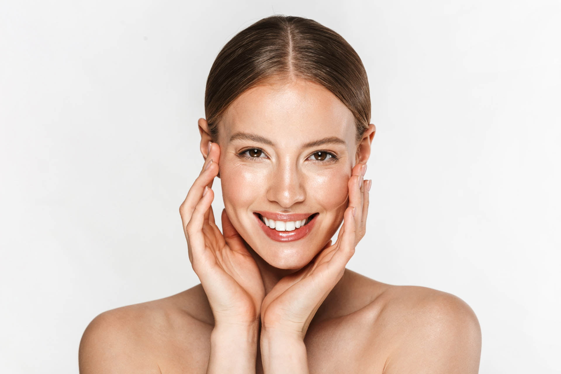 A beautiful young woman posing with her hands on her face in the comfort of her home.