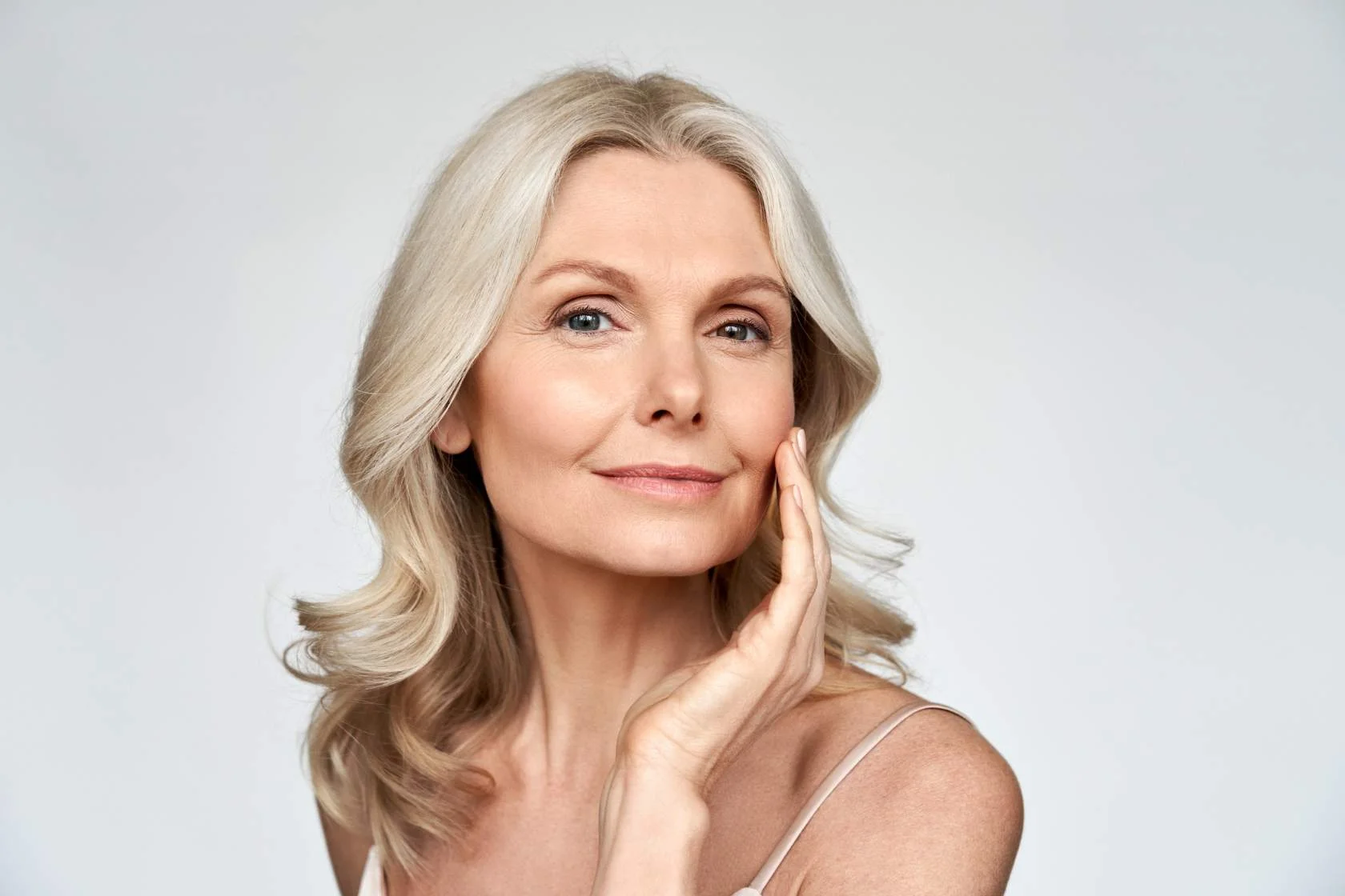 A woman posing with her hand on her face who offers services.