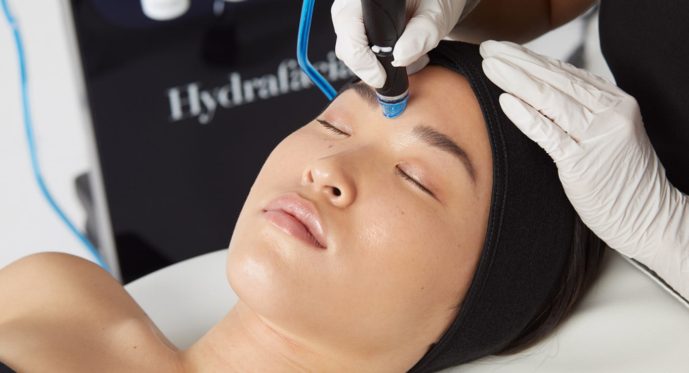 A woman receiving a HydraFacial treatment.