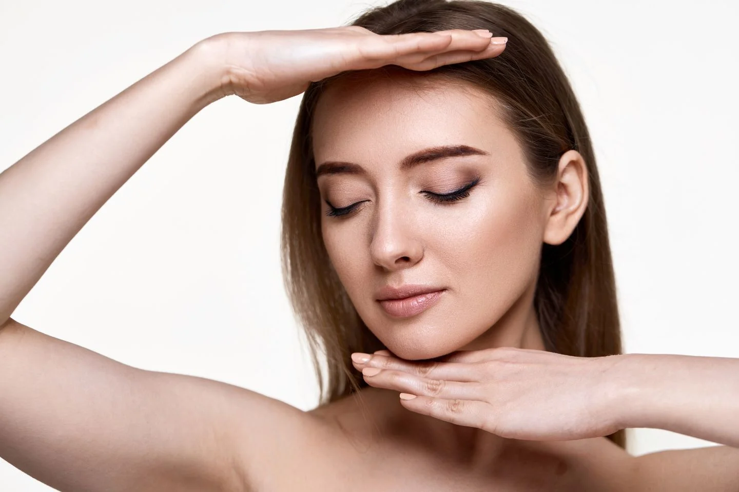 A stunning woman with her hands on her head exuding pure Hydrinity.