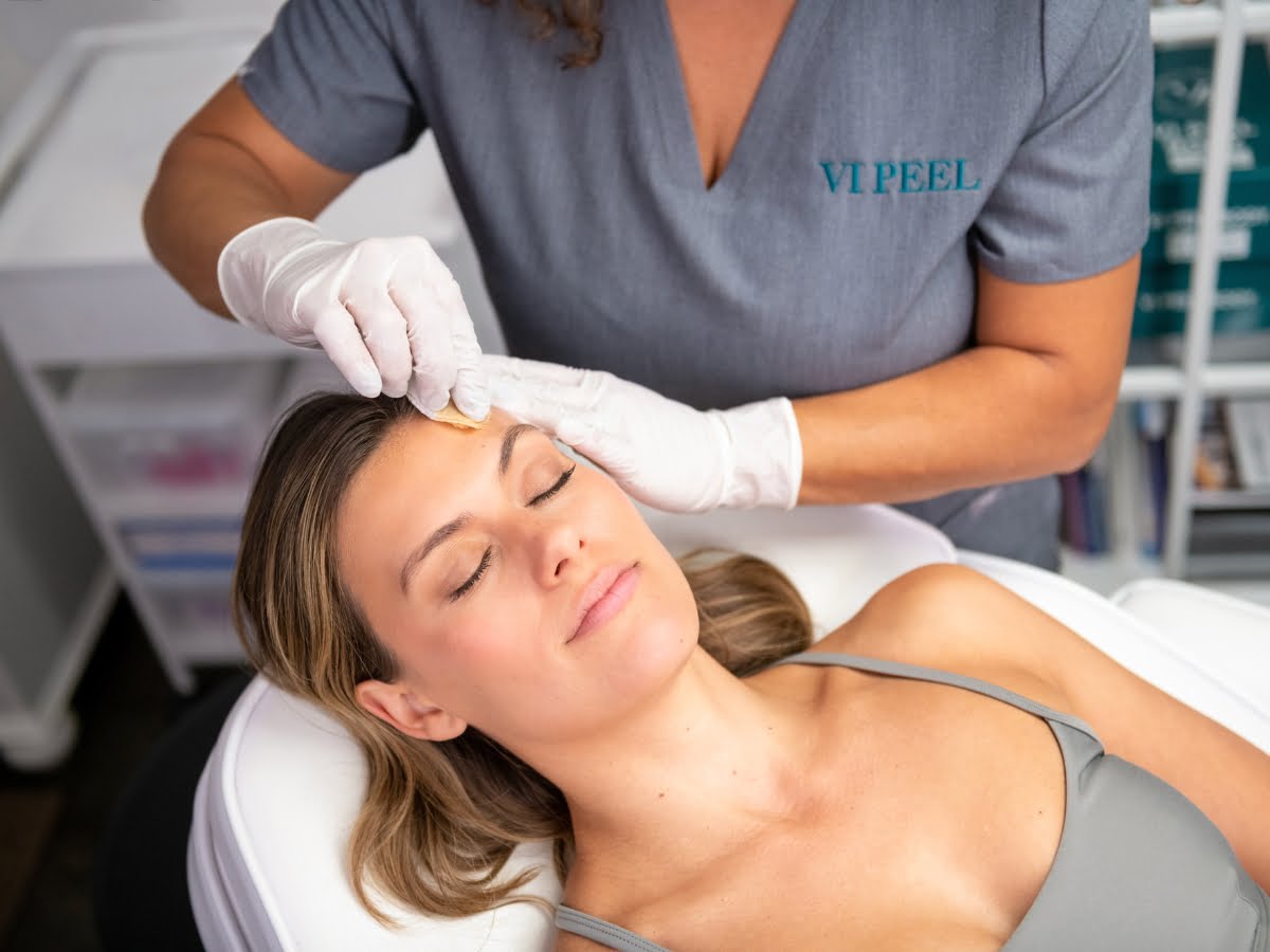 A woman receiving chemical peels facial treatment at a beauty salon.