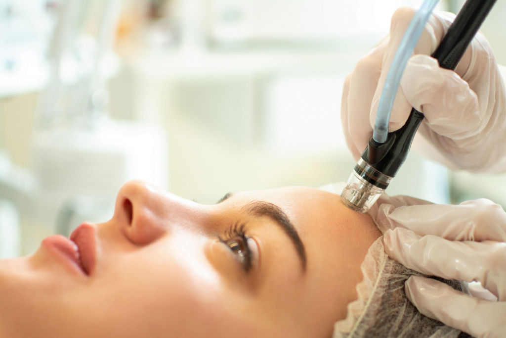 A woman experiencing the benefits of a hydrafacial treatment at a beauty salon.