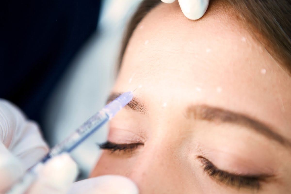 A person receiving the benefits of Botox, a neurotoxin treatment, for skin care.