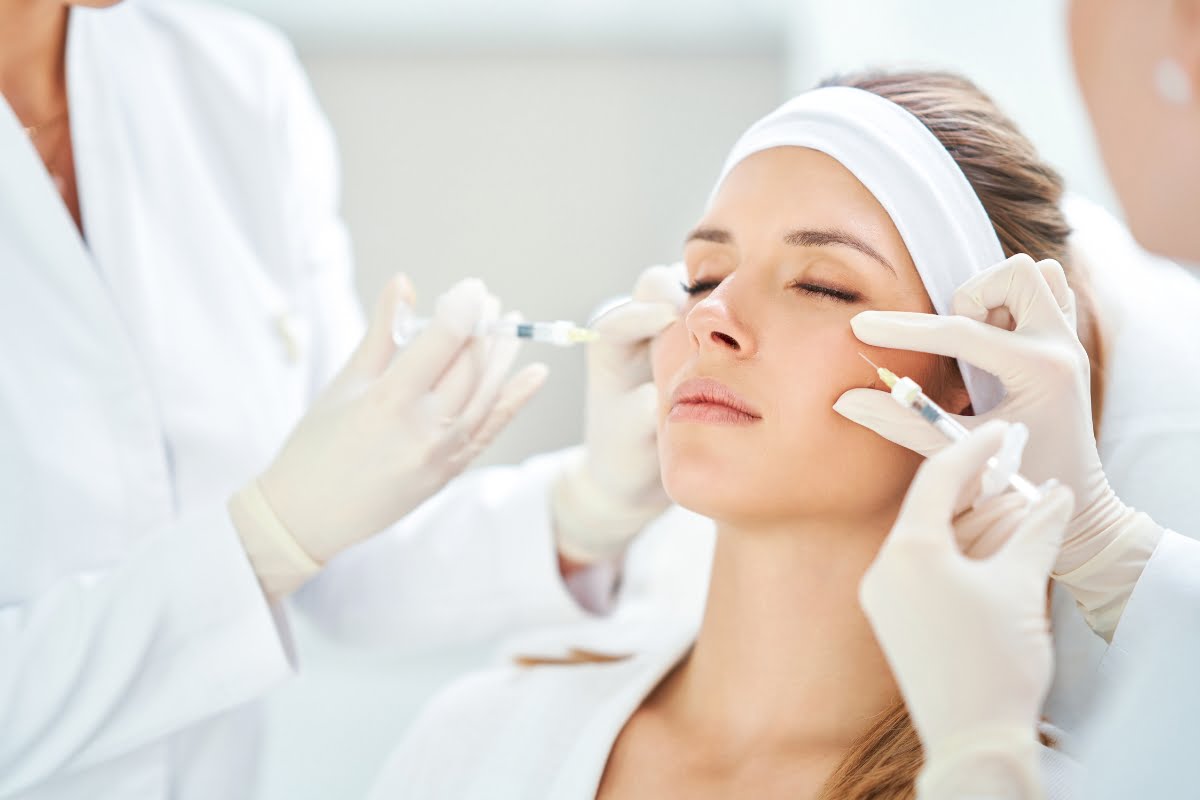 Aesthetic procedure: patient receiving facial injections of neurotoxin treatments from medical professionals.