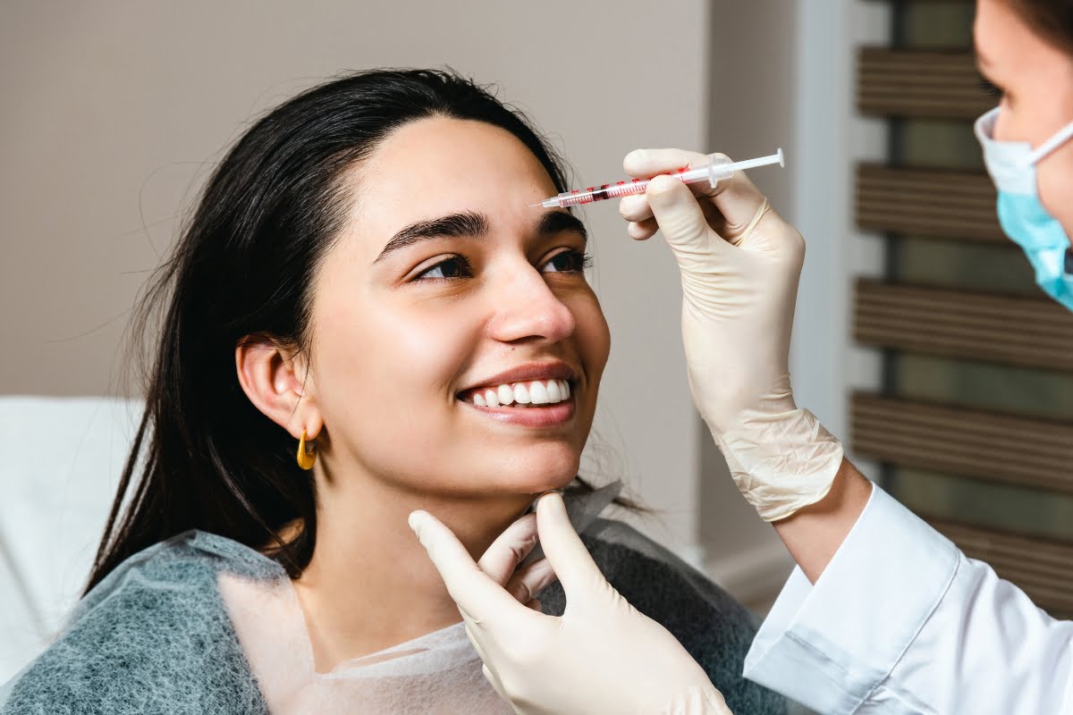 Woman receiving the benefits of a Botox neurotoxin treatment in her forehead.