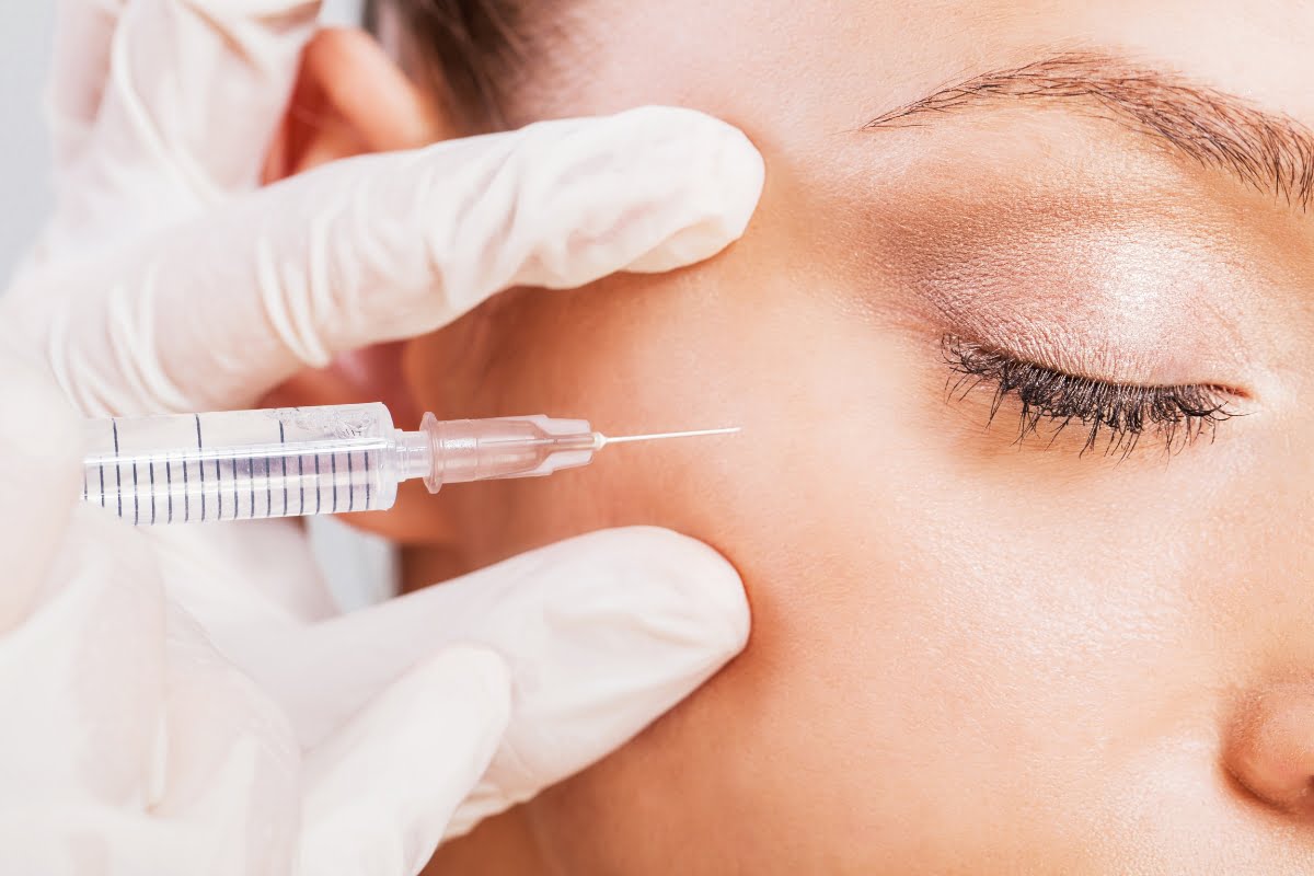 A close-up of a neurotoxin treatment involving an injection near the eye area.